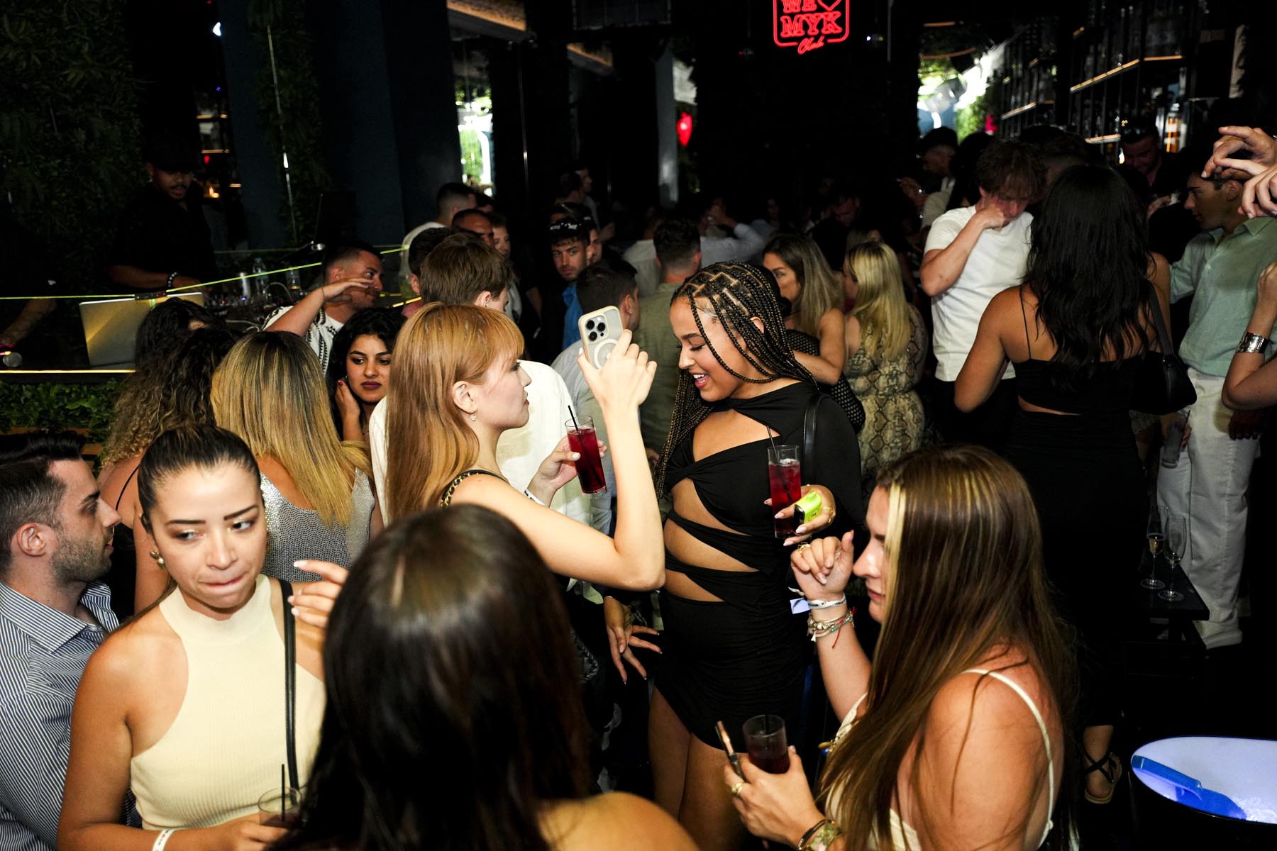 "Vibrant nightlife crowd at We Love Mykonos open-air club, Mykonos Town"