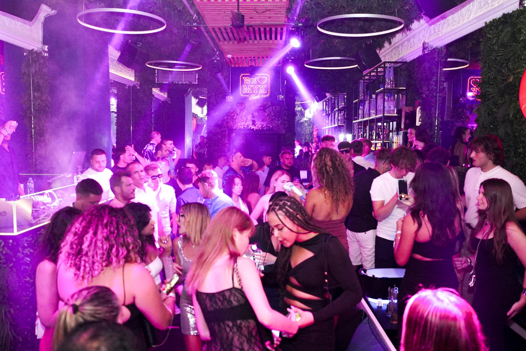 "Vibrant nightlife crowd at We Love Mykonos open-air club, Mykonos Town"
